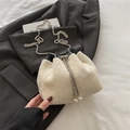 White faux fur bucket bag with silver chain strap and pearl charms on grey suit - White