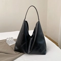 Minimalist black oversized hobo tote bag in soft leather finish on white background - Black