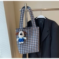 Close-up of houndstooth canvas tote bag with a cute white dog plush pendant on the handle - With Pendant / Blue