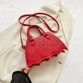 Red bat-wing handbag with black spider web embroidery and adjustable crossbody strap - Red