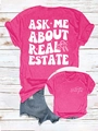 Détail d'un t-shirt rose vif avec texte 'ASK ME ABOUT REAL ESTATE' et motif de maison - Rose Rouge (Graphique Blanc)