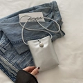 Mini silver metallic phone crossbody bag featuring a large pearl buckle and thin strap - Silver