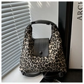 Detailed view of leopard print canvas tote with black leather flap and round handle - Black