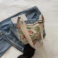Floral embroidered crescent shoulder bag in cream with adjustable strap for casual wear - Off White