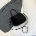 Fashionable black faux fur crossbody handbag with gold hardware and leather strap - Black