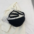 Minimalist black crescent nylon shoulder bag with adjustable strap on white fabric - Black