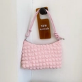 Pink bubble textured hobo shoulder bag with a knotted strap and zipper closure - Pink