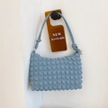 Minimalist light blue bubble textured shoulder bag with chic knotted strap design - Blue