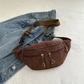 Brown corduroy waist bag with adjustable strap and multiple zipper pockets shown on denim - Brown