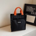 Borsa tote minimalista in tela nera con manici arancioni vivaci ed etichetta fashion - Nero