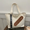 Minimalist cream canvas tote bag with black lettered strap and brown leather accents - Off White