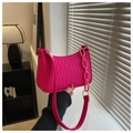 Close-up of fuchsia crescent bag with embossed crocodile texture and chunky chain detail - Rose Red