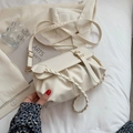 Chic beige pleated crossbody bag with gold buckle and woven edge on neutral suit background - Off White