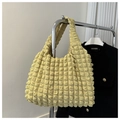 Detail of cream puff shoulder bag featuring unique popcorn texture and minimalist handle - Light Yellow