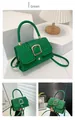 Detailed view of green quilted leather bag with large golden square buckle and handle - Green