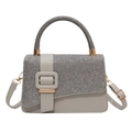 Detail of grey PU leather and sparkling sequin texture with a gold square buckle accent - Gray