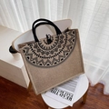 Linen tote bag with black tribal geometric print and woven handles on a white chair - Horizontal / Khaki
