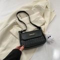 Chic black quilted shoulder bag with gold logo plate and cute sunglasses plush charm - Black