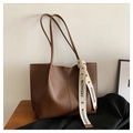 Detail of coffee brown tote bag with decorative fashion ribbon on long handles - Coffee