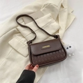 Dark coffee crossbody bag with quilted texture and white fur pompom bag charm - Coffee