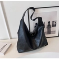 Detail of minimalist black PU leather tote bag with soft texture and vertical stitching - Black
