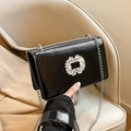 Black glossy crossbody square bag featuring a crystal flower buckle and silver chain - Black
