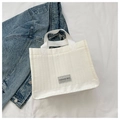 Detail of white quilted tote bag with Fashion Bag label and reinforced leather base - White
