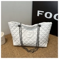 Close-up of white quilted PU tote bag with chain straps and embossed round logo - White