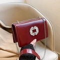 Glossy burgundy leather crossbody bag with a sparkling rhinestone flower buckle and chain - Red
