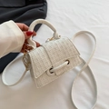 White mini crossbody handbag featuring woven texture and gold hardware details - White