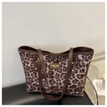 Dettaglio della borsa tote leopardata con manici in pelle marrone e placca logo - Rosa