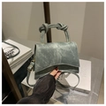 Detail of green denim crossbody bag with twisted handle and asymmetrical curved bottom - Vintage Blue