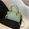 Mint green crocodile embossed crossbody bag with a woven handle and gold accents - Light Green