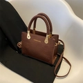 Dark brown faux crocodile texture handbag with woven handles and gold lettering - Coffee