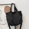 Minimalist black canvas tote bag with metal grommets and dual straps in a variant black finish - Black