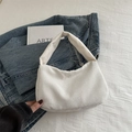 Chic beige corduroy hobo shoulder bag with textured finish on casual denim backdrop - White