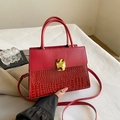 Elegant red contrast handbag with crocodile texture and gold clasp detail - Red