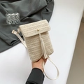 Detail of cream woven crossbody bag featuring fringe tassel and adjustable leather strap - Khaki