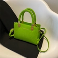 Bright green crocodile pattern crossbody bag with unique woven ring handles and gold text - Kiwi Green