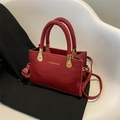 Dark red crocodile pattern handbag with woven handle and gold hardware detail - Burgundy