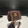 Chic burgundy matte leather shoulder bag with gold chain strap and interlocking buckle - Brown