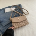 Quilted beige crossbody bag with a white butterfly clasp and adjustable strap - Khaki