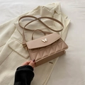 Elegant beige quilted crossbody bag with butterfly buckle and top handle details - Khaki