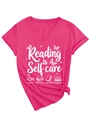 Detail of pink V-neck T-shirt with Reading is Self care print and side knot design - Rose Red (White Graphic)