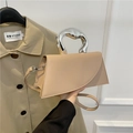 Beige faux leather crossbody bag with distinctive silver molten metal handle design - Khaki