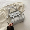 Silver rectangular faux leather backpack with metallic star buckles and a top handle - Silver