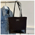 Dettaglio borsa tote nera in tela con cuori, ciondolo a fiocco e base in finta pelle - Cuore Nero