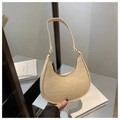 Close-up of beige faux crocodile skin texture on a half-moon shaped underarm handbag - Khaki