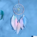 Handmade dream catcher wall hanging with pastel feathers and beads on blue background - Rainbow Dream (No Light)