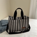 Black and white striped canvas tote bag with adjustable strap and leather patch - Black